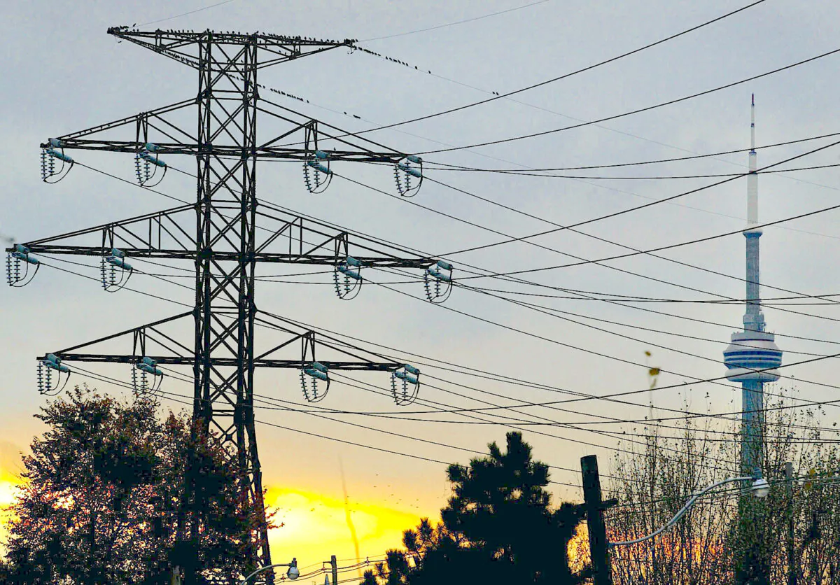 A hydro tower is seen with the CN Tower as a backdrop in downtown Toronto in a file photo.
(CP PHOTO/Kevin Frayer)