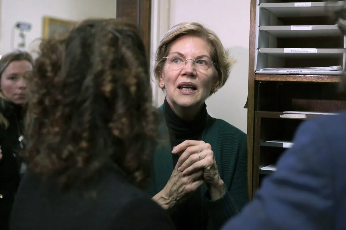 Democratic presidential candidate Sen. Elizabeth Warren (D-Mass.) speaks with supporters after filing to have her name listed on the New Hampshire primary ballot in Concord, N.H. on Nov. 13, 2019. (Charles Krupa/AP Photo)