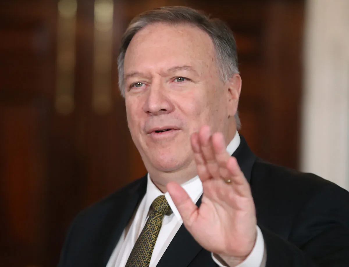 Secretary of State Mike Pompeo waves while meeting with NATO Secretary General Jens Stoltenberg during the Global Coalition to Defeat ISIS conference, at the State Department in Washington on Nov. 14, 2019. (Mark Wilson/Getty Images)