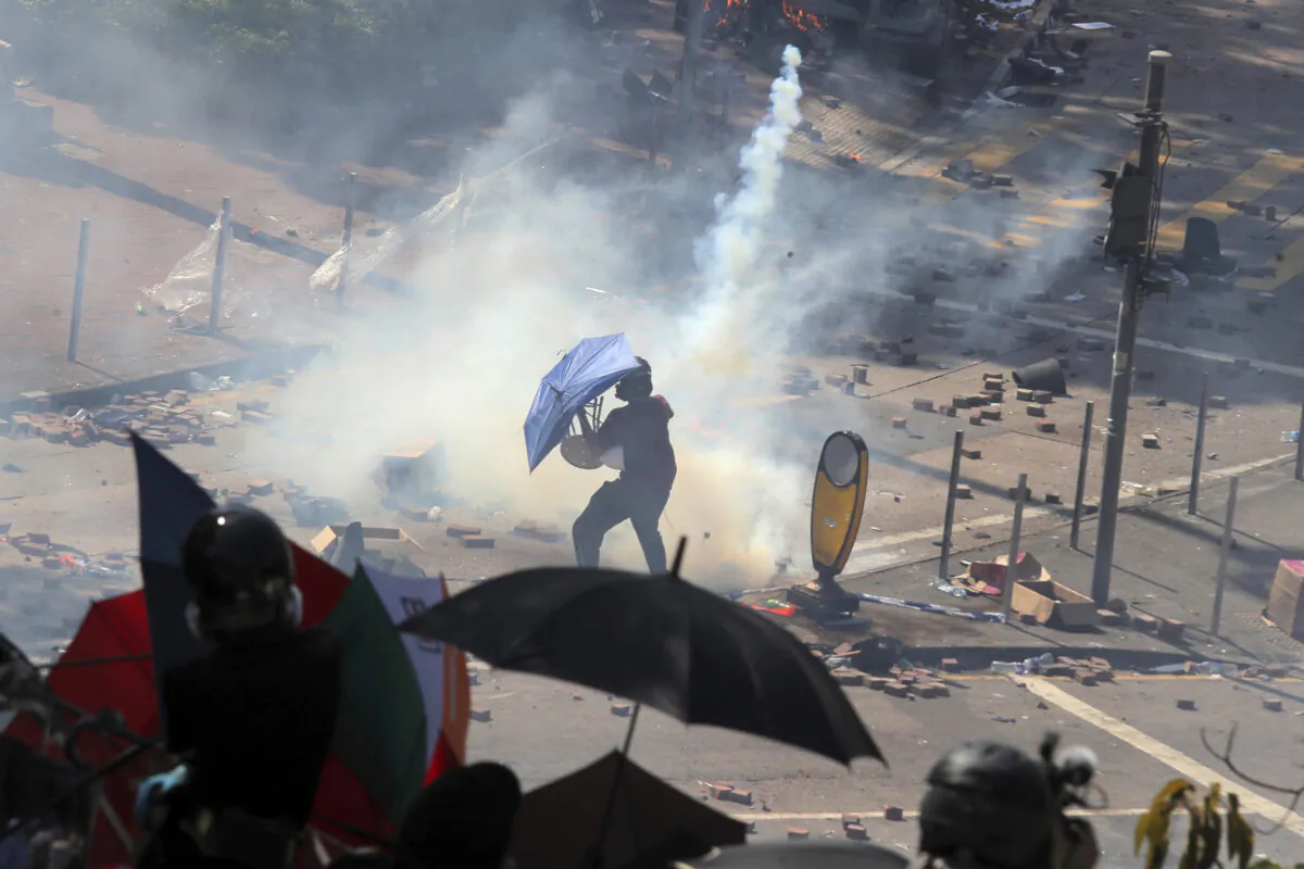 A protestor reacts as police fire tear gas at Hong Kong Polytechnic University in Hong Kong, on Nov. 17, 2019. (AP Photo/Kin Cheung)