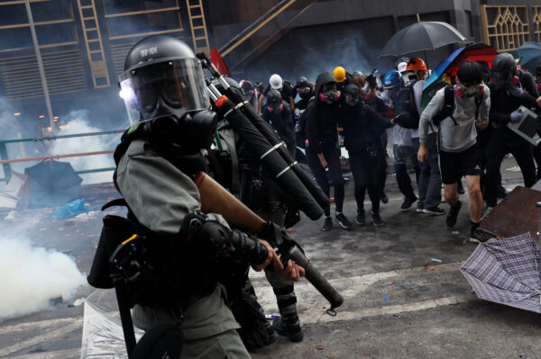 Protesters attempt to escape from tear gas