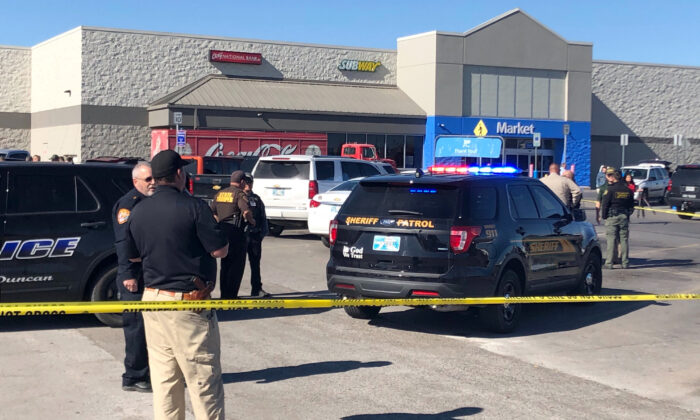Law enforcement work the scene where two men and a woman were fatally shot outside a Walmart store in Duncan, Okla., on Nov. 18, 2019. (Sean Murphy/AP Photo)