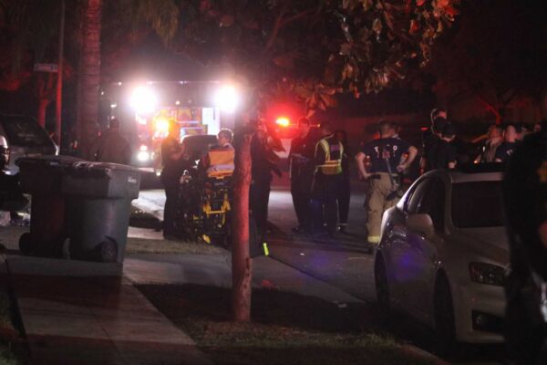 Police and emergency personnel work at the scene of a shooting