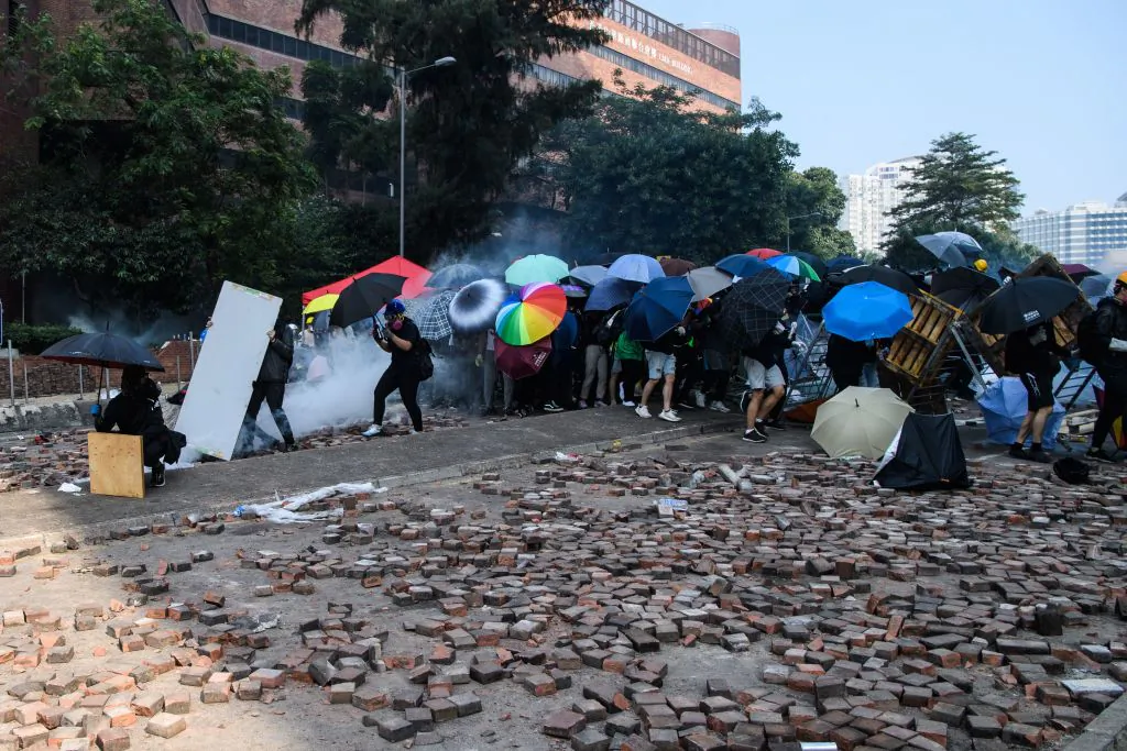 Protesters attempt to escape the campus of the Hong Kong Polytechnic University after it was surrounded by police in the Hung Hom district of Hong Kong on Nov. 18, 2019. (Anthony Wallace/AFP via Getty Images)