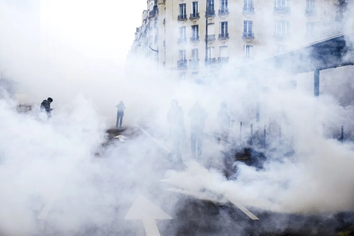 Tear gas envelopes protesters during a yellow vest demonstration marking the first anniversary in Paris, on Nov. 16, 2019. (Kamil Zihnioglu/AP Photo)