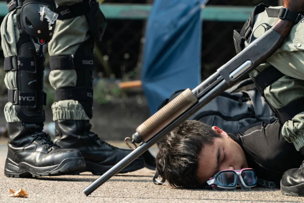  A protester is detained by police as he tries to escape from The Hong Kong Poytechnic University in Hong Kong on Nov. 18, 2019. (Anthony Kwan/Getty Images)
