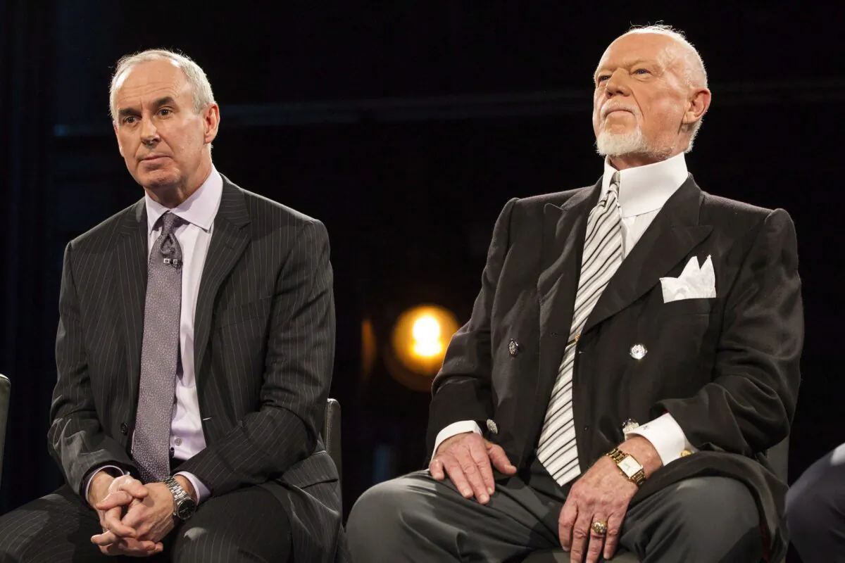 Ron MacLean (L) sits beside Don Cherry as Rogers TV unveils their team for the station's NHL coverage in Toronto on March 10, 2014. MacLean addressed Don Cherry's dismissal during the first intermission of Saturday's "Hockey Night in Canada" broadcast. (The Canadian Press/Chris Young)
