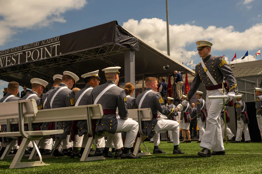 A graduating cadet walks with his diploma as he is congratulated by a classmate during graduation ceremony of the U.S. Military Academy Class of 2019 graduation ceremony at Michie Stadium in West Point, New York, on May 25, 2019. (David Dee Delgado/Getty Images)