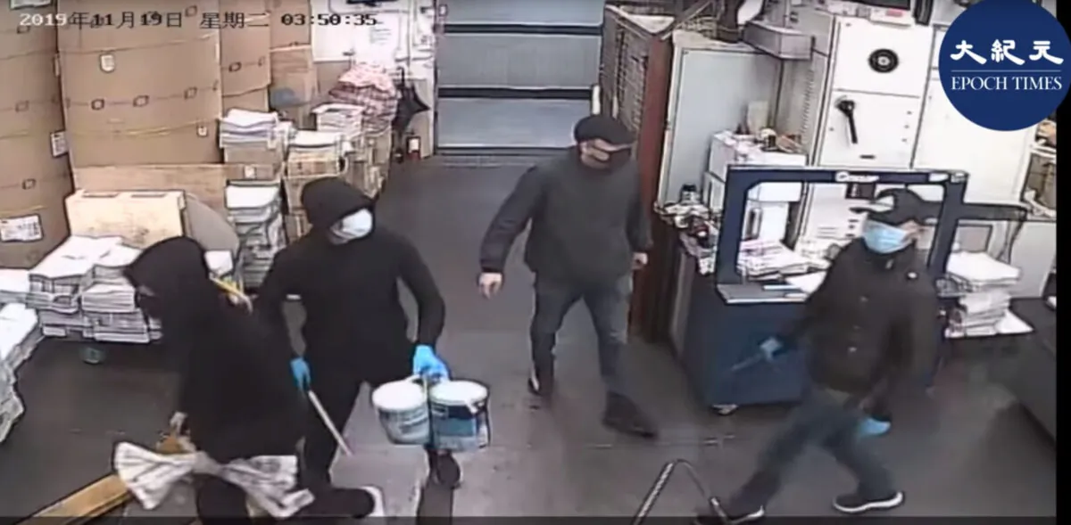 Surveillance footage showing four masked men entering the Hong Kong Epoch Times print shop before threatening workers and setting a fire on Nov. 19, 2019. (Epoch Times)