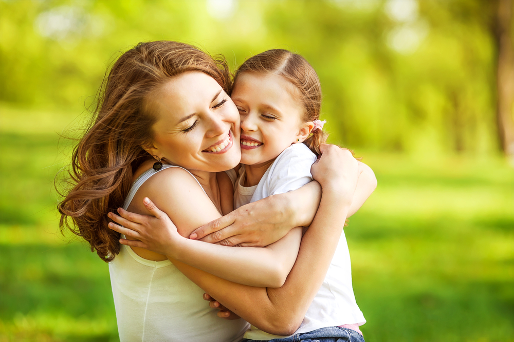 mother and daughter hugging. 