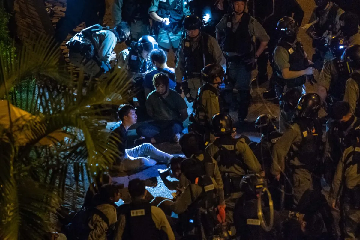 Police detain protesters and students after they tried to flee outside the Hong Kong Polytechnic University campus in the Hung Hom district in Hong Kong, on Nov. 19, 2019. (Billy H.C. Kwok/Getty Images)