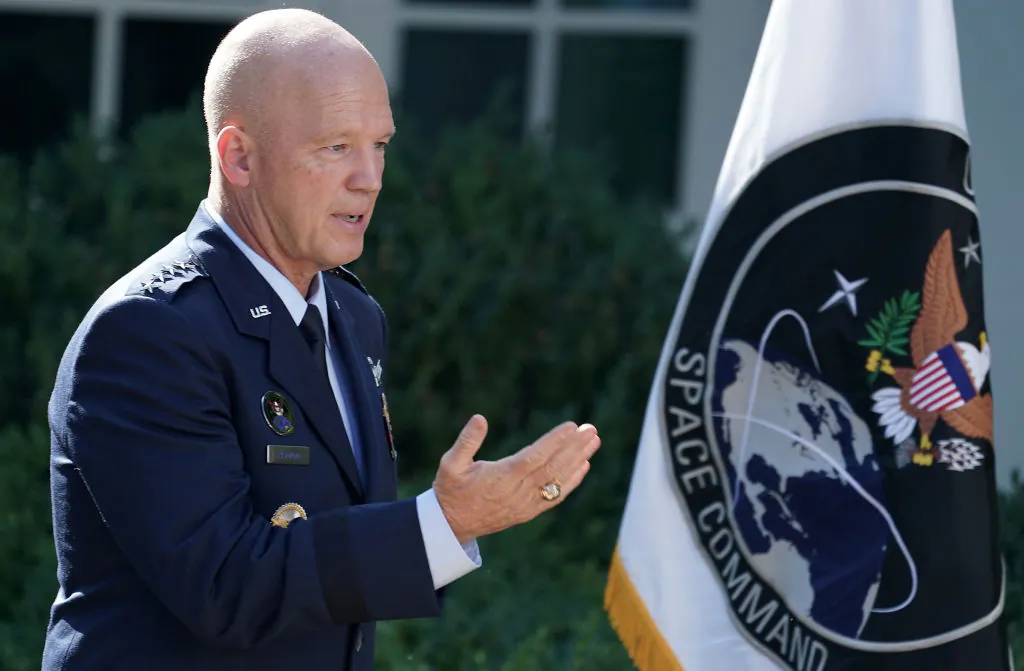 U.S. Air Force Space Command Gen. John "Jay" Raymond stands next to the flag of the newly established U.S. Space Command, the sixth national armed service, in the Rose Garden at the White House on Aug. 29, 2019. (Chip Somodevilla/Getty Images)