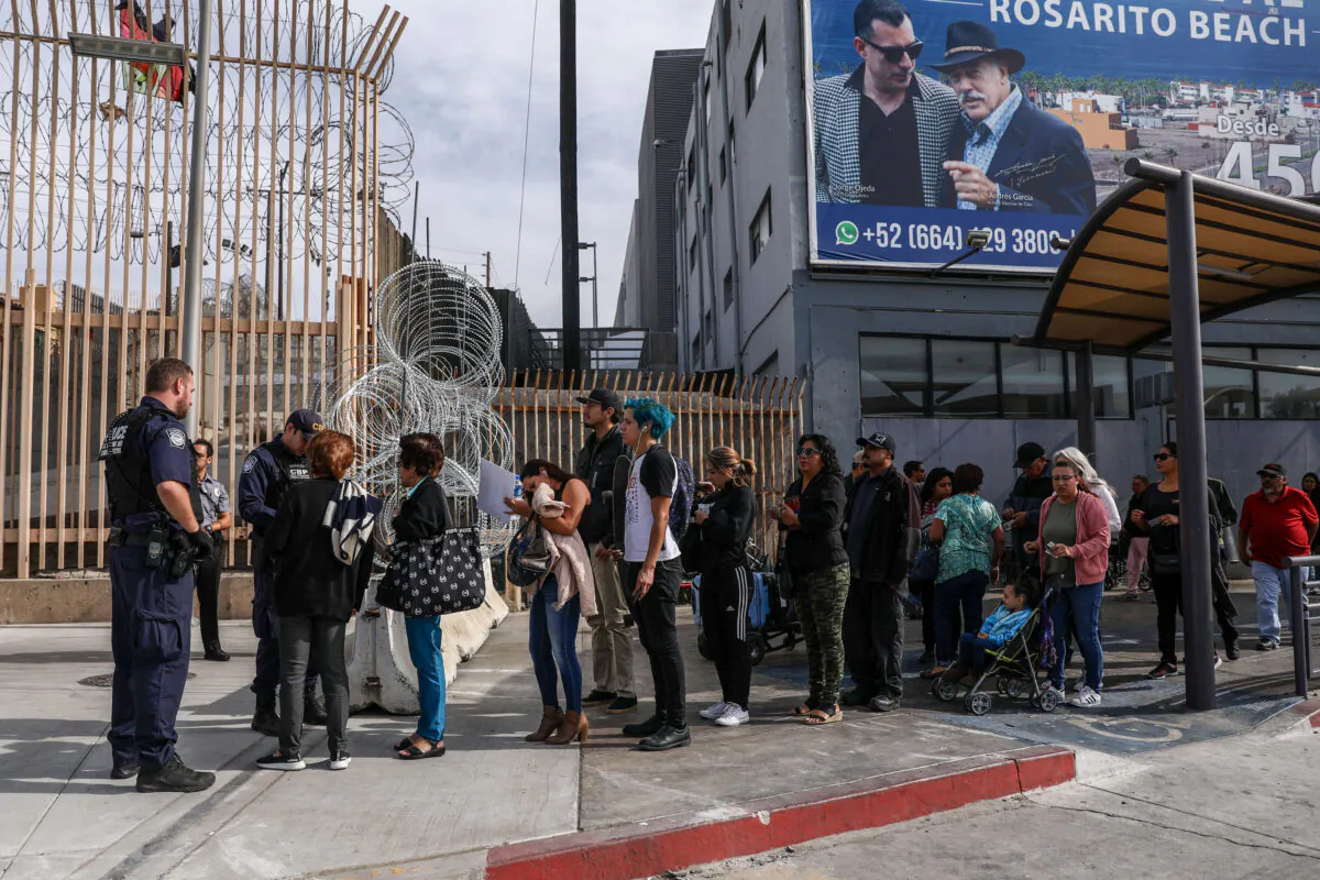 Customs and Border Protection agents check pedestrians as they exit Mexico into the customs area of the United States on the east side of the San Ysidro port of entry in Tijuana, Mexico, on Nov. 19, 2018. (Charlotte Cuthbertson/The Epoch Times)
