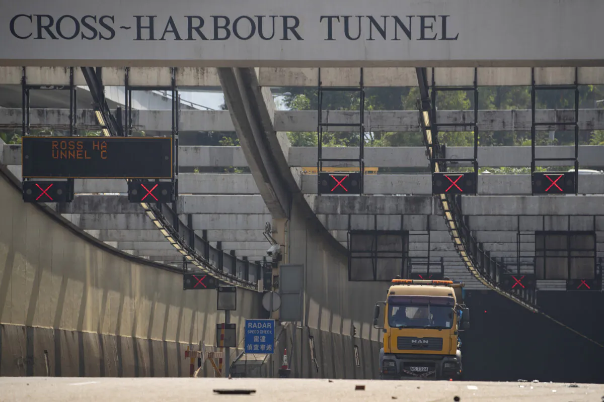 A truck is parked at the entrance to the Cross-Harbor Tunnel as clean up operations begin outside the Hong Kong Polytechnic University in Hong Kong on Nov. 20, 2019. (Ng Han Guan/AP Photo)