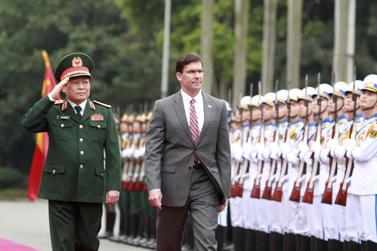 U.S. Defense Secretary Mark Esper (R) and Vietnamese Defense Minister Ngo Xuan Lich review an honor guard in Hanoi, Vietnam on Nov. 20, 2019. Esper is on a visit to Vietnam to strengthen the military relations with the Southeast Asian nation. (Hau Dinh/AP)