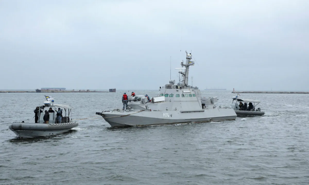 Ukrainian servicemen tug the vessel Nikopol, one of three Ukraine naval ships captured in the Kerch Strait in November 2018 and then returned by Russia, in the port of Ochakiv, Ukraine, on Nov. 20, 2019. (Oleg Novikov/Reuters)