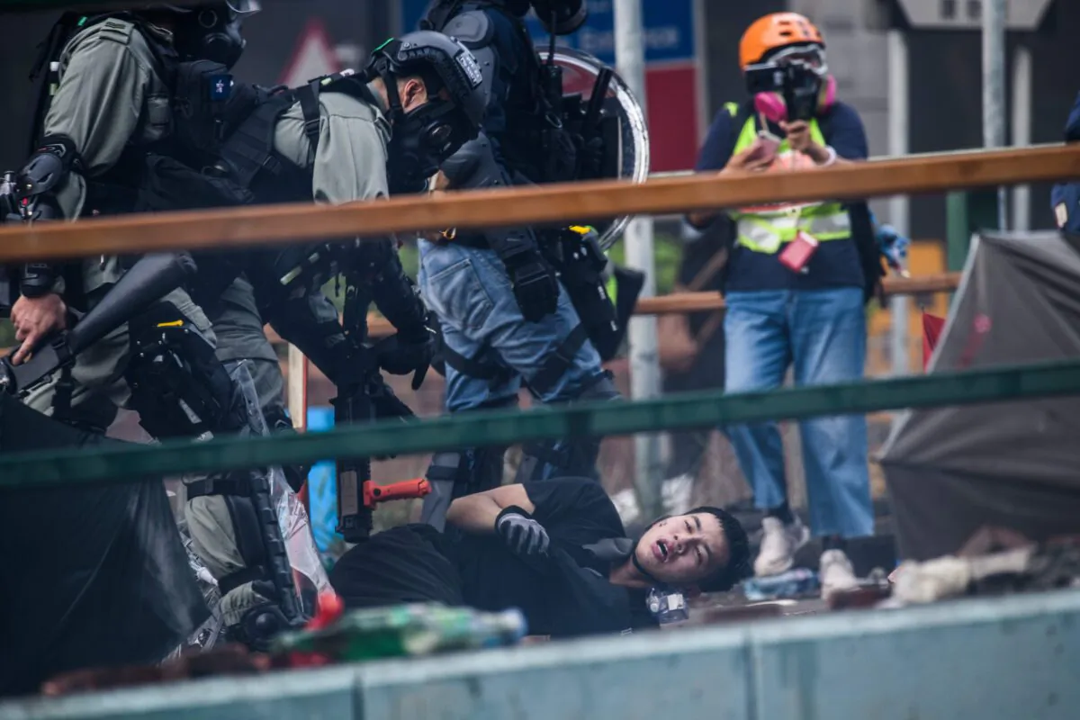 Protesters are detained by police near the Hong Kong Polytechnic University in the Hung Hom district of Hong Kong on Nov. 18, 2019. (Anthony Wallace/AFP via Getty Images)