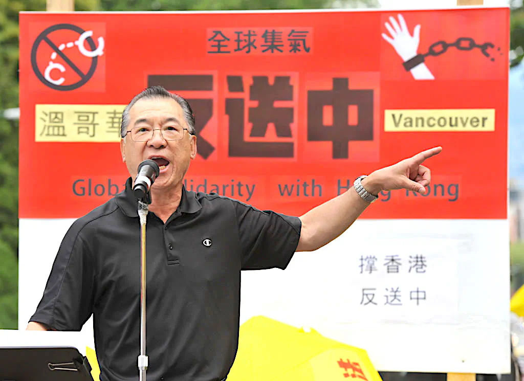 Rally organizer Kenneth Tung addresses demonstrators gathered in front of the Chinese Consulate in Vancouver on June 9, 2019, to protest against a controversial extradition law proposed by Hong Kongs pro-Beijing government to ease extraditions to China. (Don MacKinnon/AFP via Getty Images)