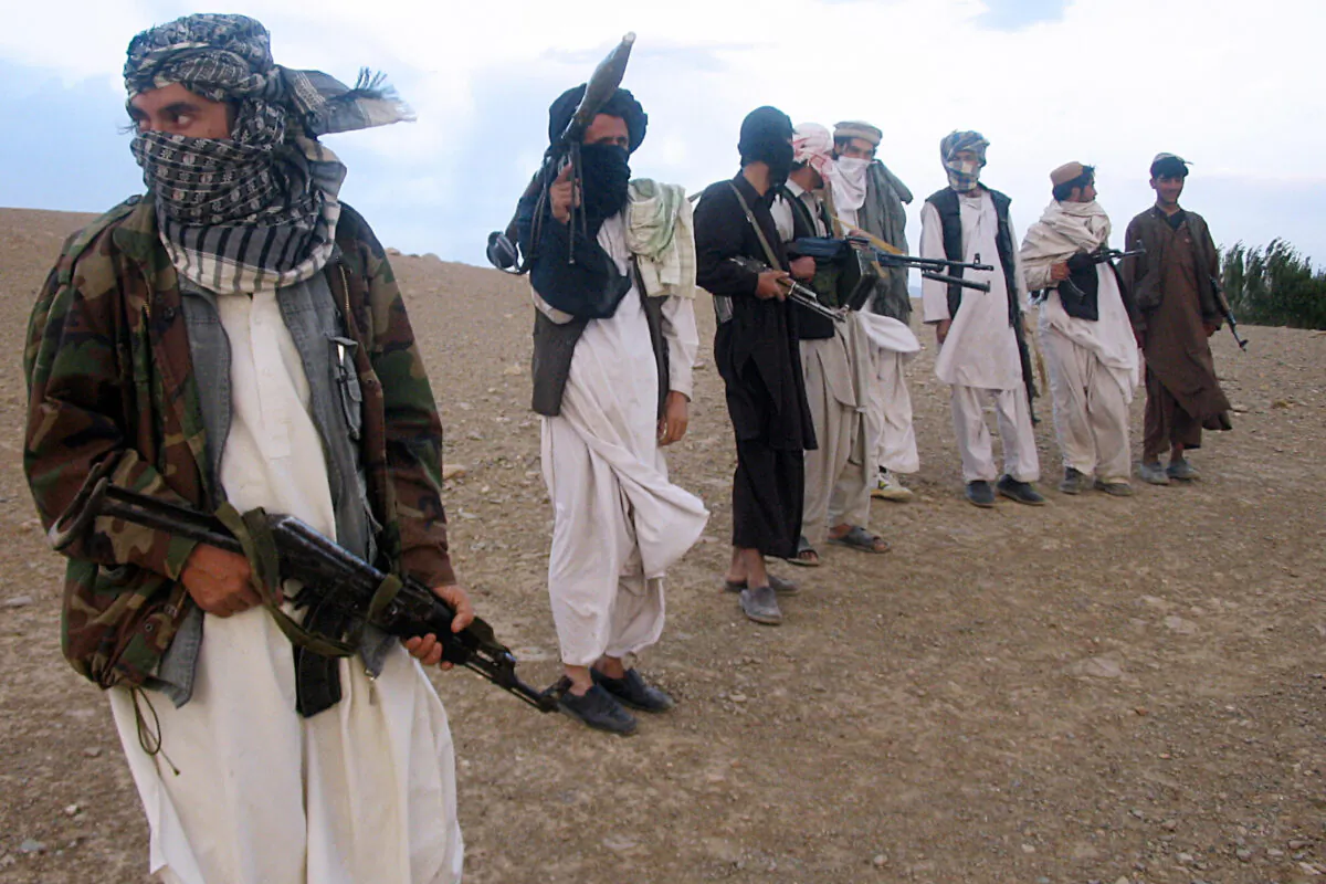 Taliban terrorists stand on a hillside at Maydan Shahr in Wardak province, west of Kabul, Afghanistan, on Sept. 26, 2008. (Photo credit should read STR/AFP via Getty Images)