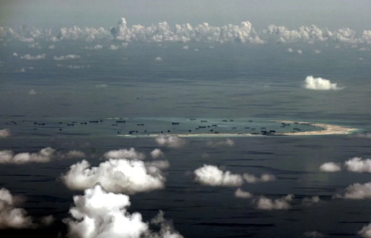 An aerial photo taken though a glass window of a Philippine military plane shows the alleged on-going land reclamation by China on mischief reef in the Spratly Islands in the South China Sea, west of Palawan, Philippines, on May 11, 2015. (Ritchie B. Tongo/Pool/Reuters)