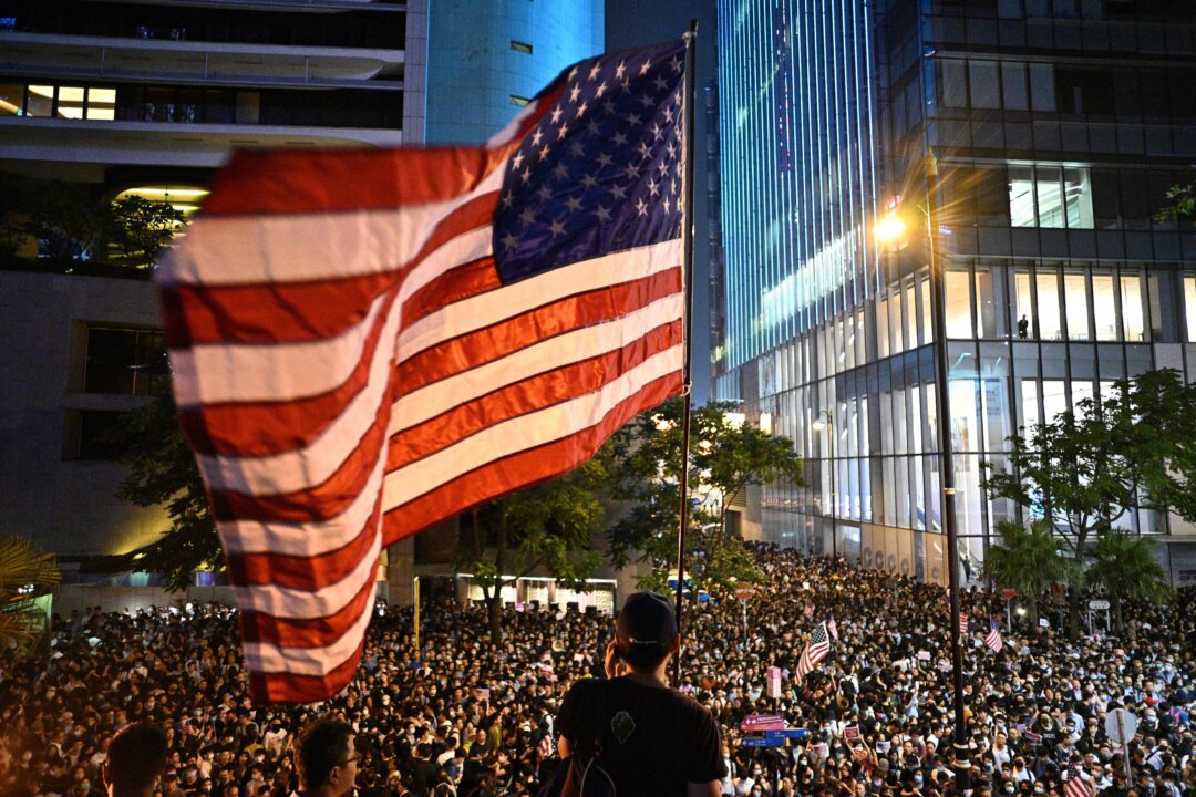 A man waves a US national flag as protesters attend a rally in Hong Kong on Oct. 14, 2019. (Anthony Wallace/AFP via Getty Images)