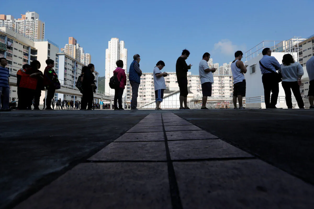 Voters line up at a polling station during district council local elections in Hong Kong, on Nov. 24, 2019. (Adnan Abidi/Reuters)