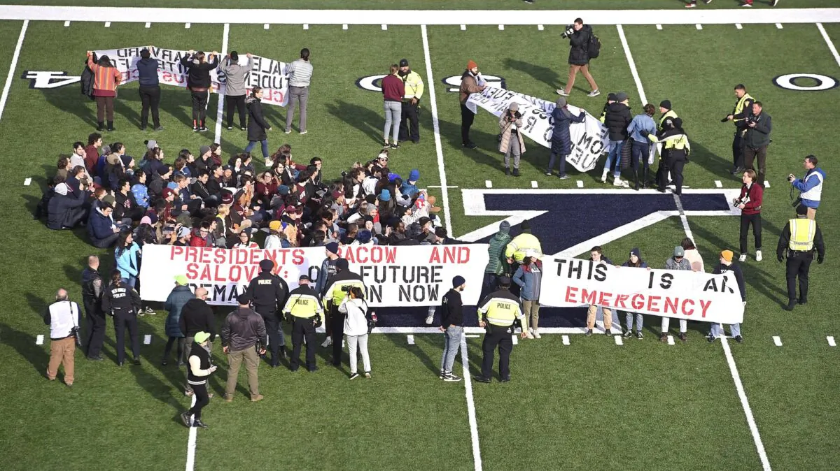 Demonstrators stage a climate change protest at the Yale Bowl delaying the start of the second half of an NCAA college football game between Harvard and Yale in New Haven, Conn., on Nov. 23, 2019. (Arnold Gold/New Haven Register via AP)