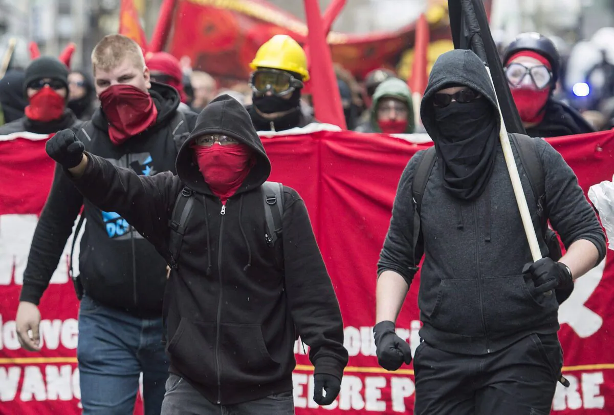 Masked demonstrators take part in an anti-capitalist protest on May Day in Montreal, on May 1, 2016. (The Canadian Press/Graham Hughes)
