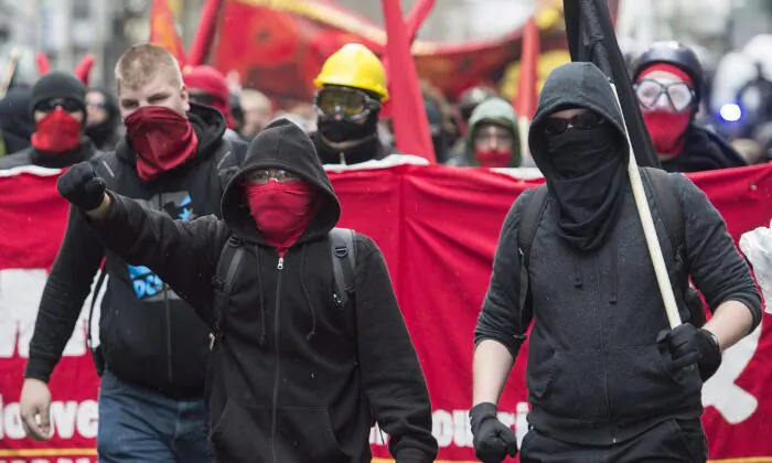 Masked demonstrators take part in an anti-capitalist protest on May Day in Montreal, on May 1, 2016. (The Canadian Press/Graham Hughes)
