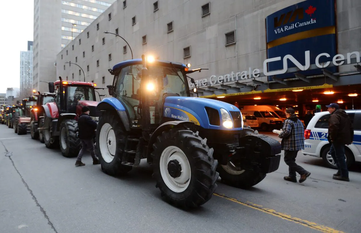 Farmers park their tractors in protest outside the Canadian National Railway headquarters in Montreal on Nov. 22, 2019. (The Canadian Press/Ryan Remiorz)