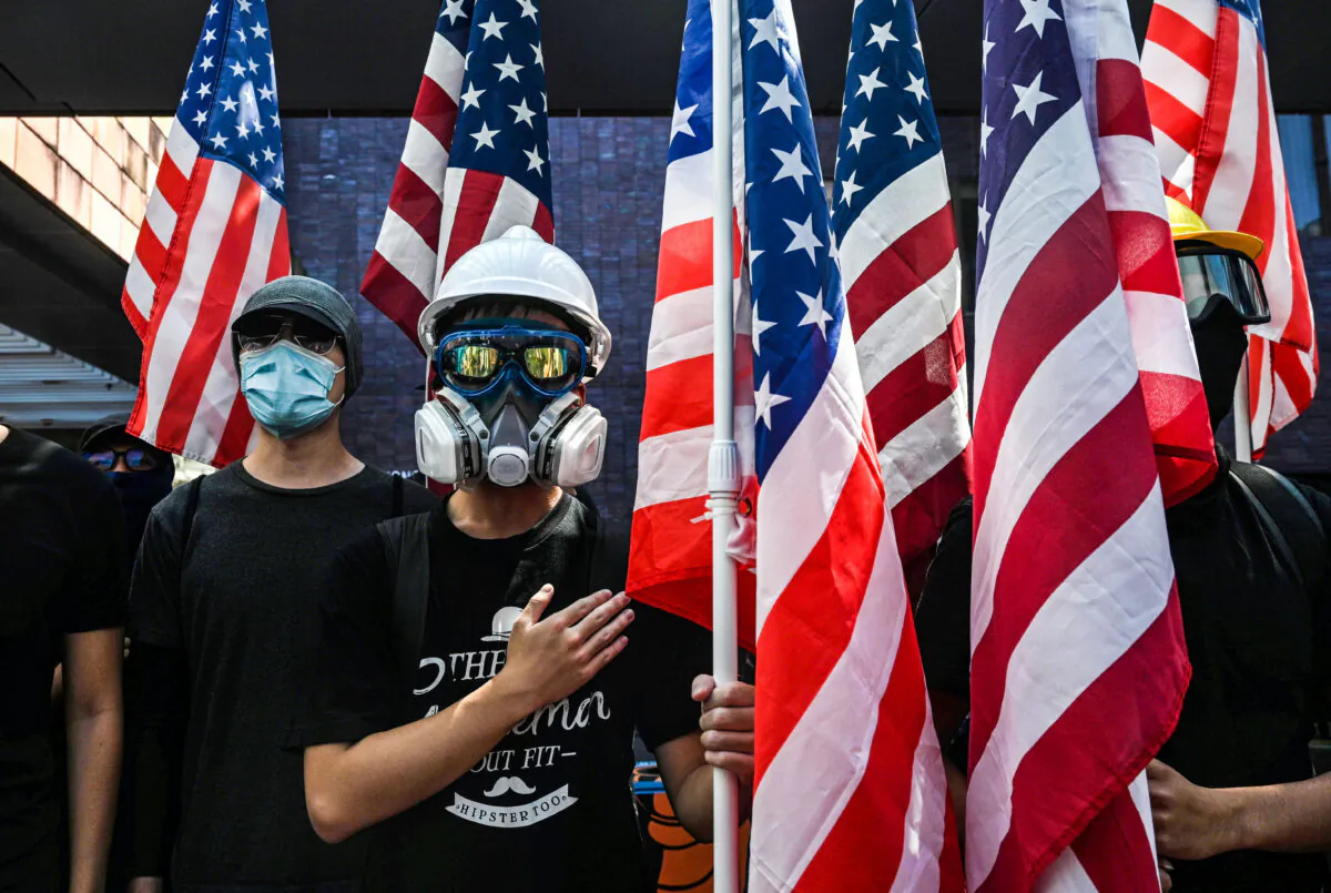 Students hold the US flag and sing the Star-Spangled Banner at Hong Kong University in Hong Kong on September 20, 2019, as they rally for the US Congress to pass the Hong Kong Human Rights and Democracy Act. (Anthony Wallace/ via AFP Getty Images)        