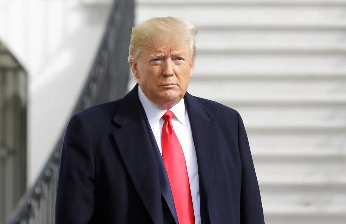 President Donald Trump holds his notes as he talks to the media on the South Lawn of the White House before boarding Marine One in Washington en route to Austin, Texas, on Nov. 20, 2019. (Joshua Lott/AFP via Getty Images)
