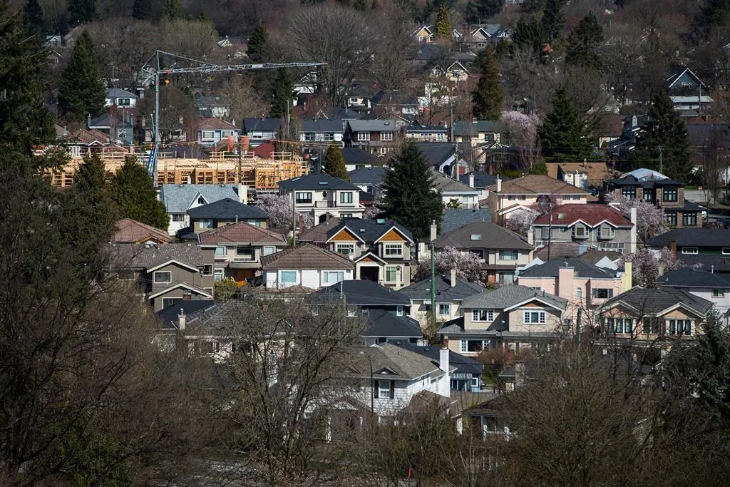A condo building is seen under construction surrounded by houses in Vancouver, B.C., in a file photo. (The Canadian Press/Darryl Dyck)