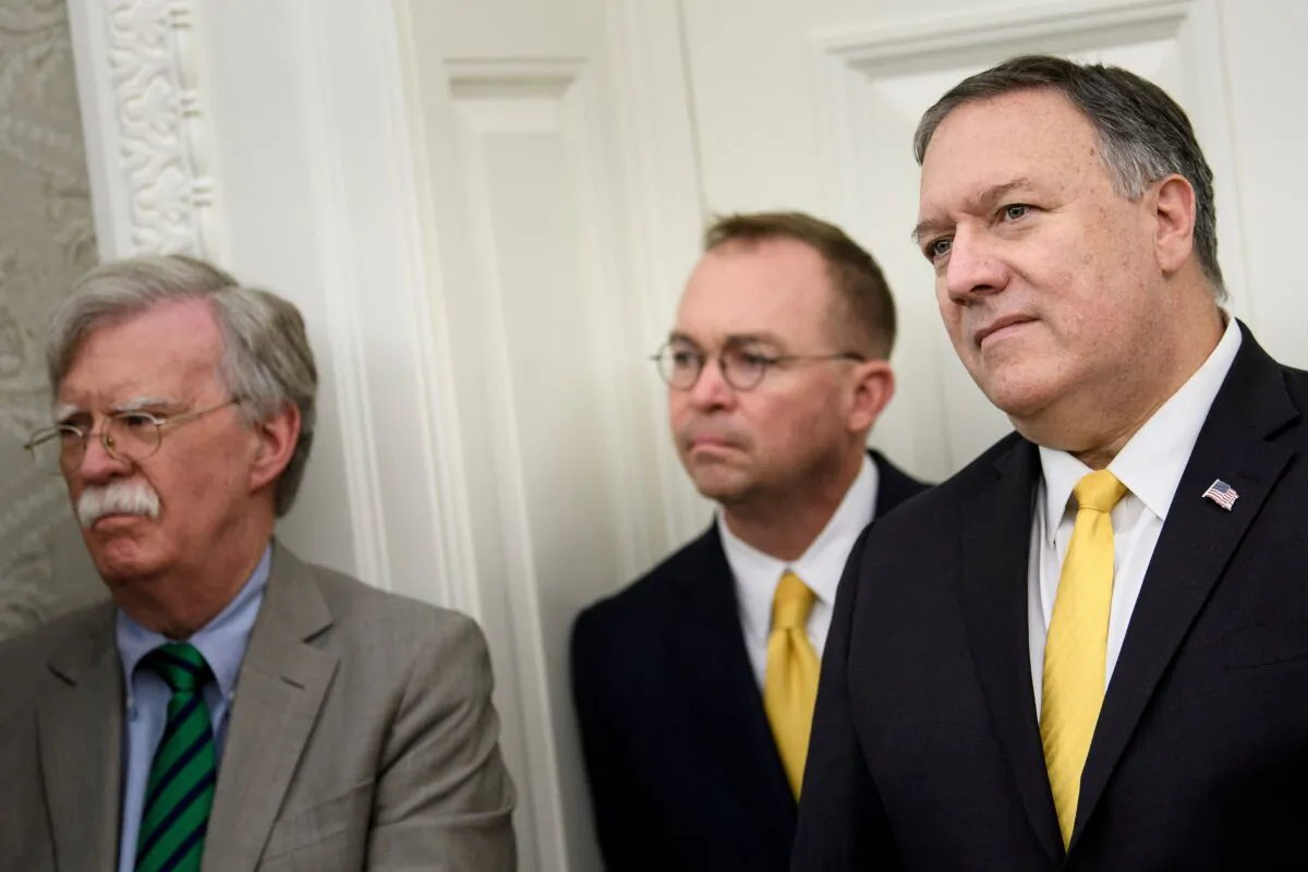 National Security Advisor John R. Bolton (L), acting White House Chief of Staff Mick Mulvaney (C), and Secretary of State Mike Pompeo listen while President Donald Trump announces an agreement with Guatemala in the Oval Office of the White House in Washington on July 26, 2019. (Brendan Smialowski/AFP via Getty Images)