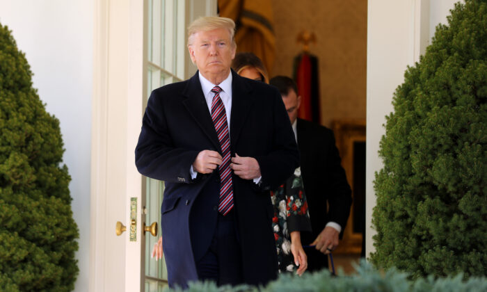 President Donald Trump steps out of the Oval Office before posing for photographs with Conan, the U.S. military K9 that assisted in the raid that killed ISIS leader Abu Bakr al-Baghdadi, on the Rose Garden colonnade at the White House Nov. 25, 2019 in Washington. (Chip Somodevilla/Getty Images)