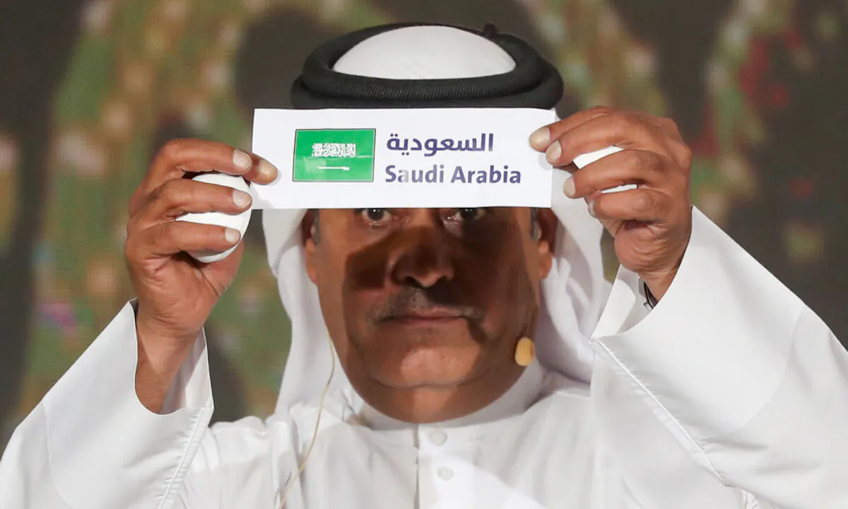 Hamed al-Hajri, a member of the Qatar Football Association, holds up the name of Saudi Arabia during the group draw for the 24th Arabian Gulf Cup in the capital Doha on Nov. 14, 2019. (Karim Jaafar/AFP via Getty Images)