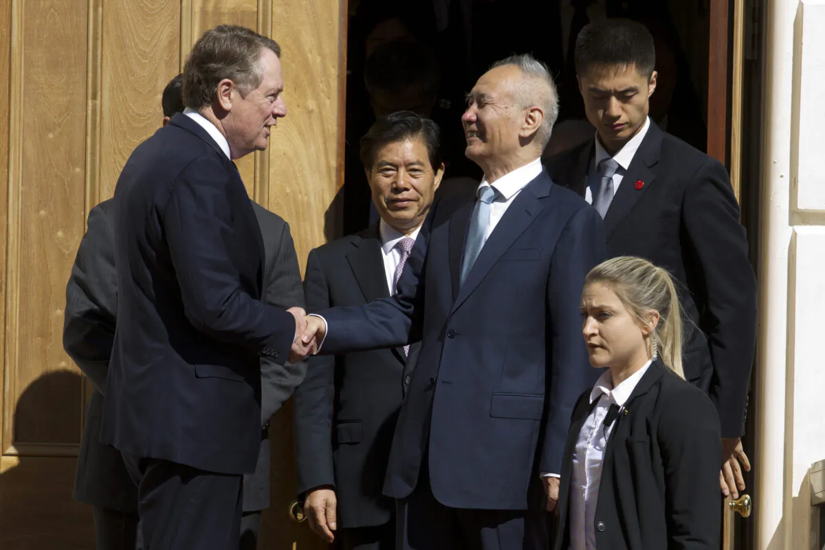 Chinese Vice Premier Liu He (center right) shakes hands with U.S. Trade Representative Robert Lighthizer (center left) after a minister-level trade meeting at the Office of the United States Trade Representative in Washington, D.C. on Oct. 11, 2019. China’s Commerce Ministry says the lead envoys in trade talks between China and the U.S. spoke on the phone and agreed to continue to work toward a preliminary agreement for resolving their tariff war. (Jose Luis Magana/AP)
