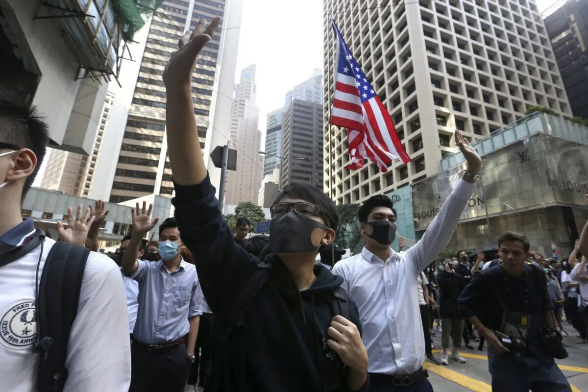 Demonstrators raise their hands during a protest in the financial district in Hong Kong on Nov. 15, 2019. (Achmad Ibrahim/AP)