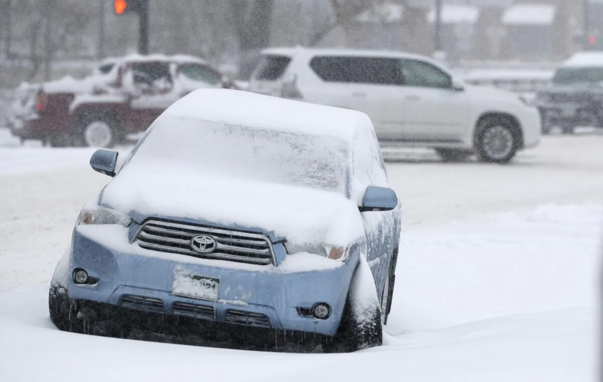 A Toyota Highlander sits abandoned after being damaged near the intersection of 6th Avenue and Speer Boulevard as a storm packing snow and high winds sweeps in over the region on Nov. 26, 2019, in Denver. (David Zalubowski/AP Photo)