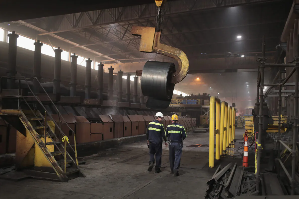 Workers remove a coil from the production line for quality-control testing during steel production at the NLMK Indiana steel mill on March 15, 2018 in Portage, Indiana. (Scott Olson/Getty Images)