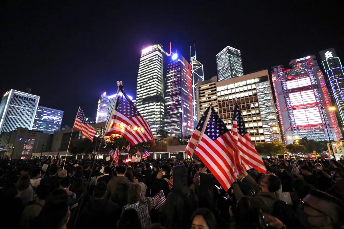 Protesters wave U.S. flags as they attend a gathering at the Edinburgh place in Hong Kong on Nov. 28, 2019. (Vincent Thian/AP Photo)