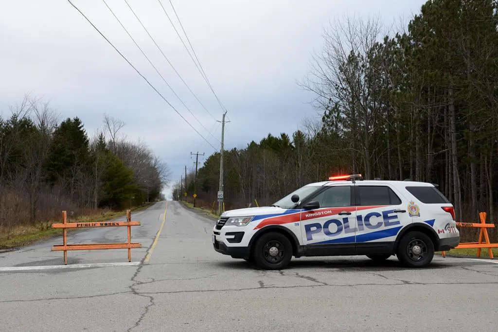 A police car blocks the end of Creekford Road in Kingston, Ontario, Canada, on Nov. 28, 2019. Police in Kingston say there are "numerous fatalities" after a small plane crashed in a wooded area within the city limits. (The Canadian Press/Sean Kilpatrick)