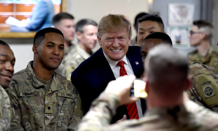 President Donald Trump serves Thanksgiving dinner to U.S. troops at Bagram Air Field during a surprise visit in Afghanistan on Nov. 28, 2019. (Olivier Douliery/AFP via Getty Images)