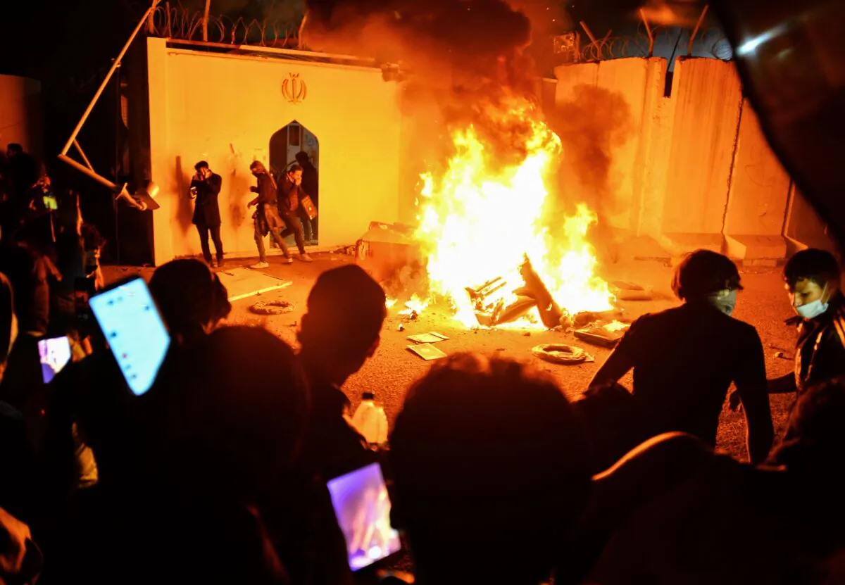 Iraqi demonstrators gather as flames start consuming Iran's consulate in the southern Iraqi Shiite holy city of Najaf on Nov. 27, 2019, two months into the country's most serious social crisis in decades. (HAIDAR HAMDANI/AFP via Getty Images)
