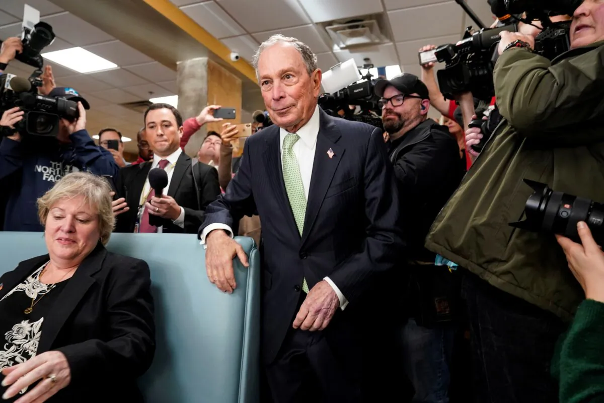 Former New York Mayor Michael Bloomberg arrives to speak with Virginia House Delegate-elect Nancy Guy after launching his presidential campaign in the D'Egg cafe in Norfolk, Virginia on Nov. 25, 2019. (Joshua Roberts/Reuters)