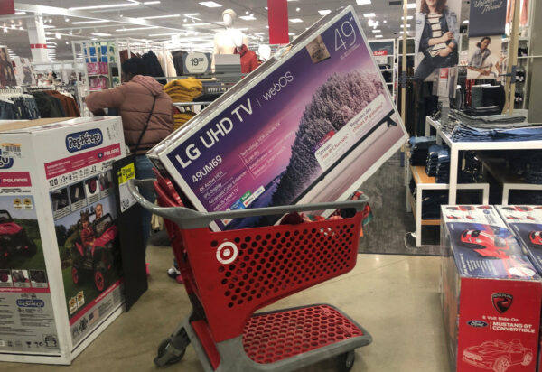 A shopping cart is filled with a television