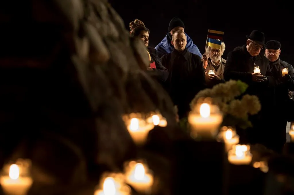 Some University of Alberta students are calling on the school to fire an assistant lecturer who denies the Holodomor, the mass genocide against Ukrainian people carried out by the Soviet Union in the 1930s. People light candles to mark a day of memory for the victims of the Holodomor in 1932-1933 at the former KGB building in Vilnius, Lithuania on Nov. 25, 2016. (AP Photo/Mindaugas Kulbis)