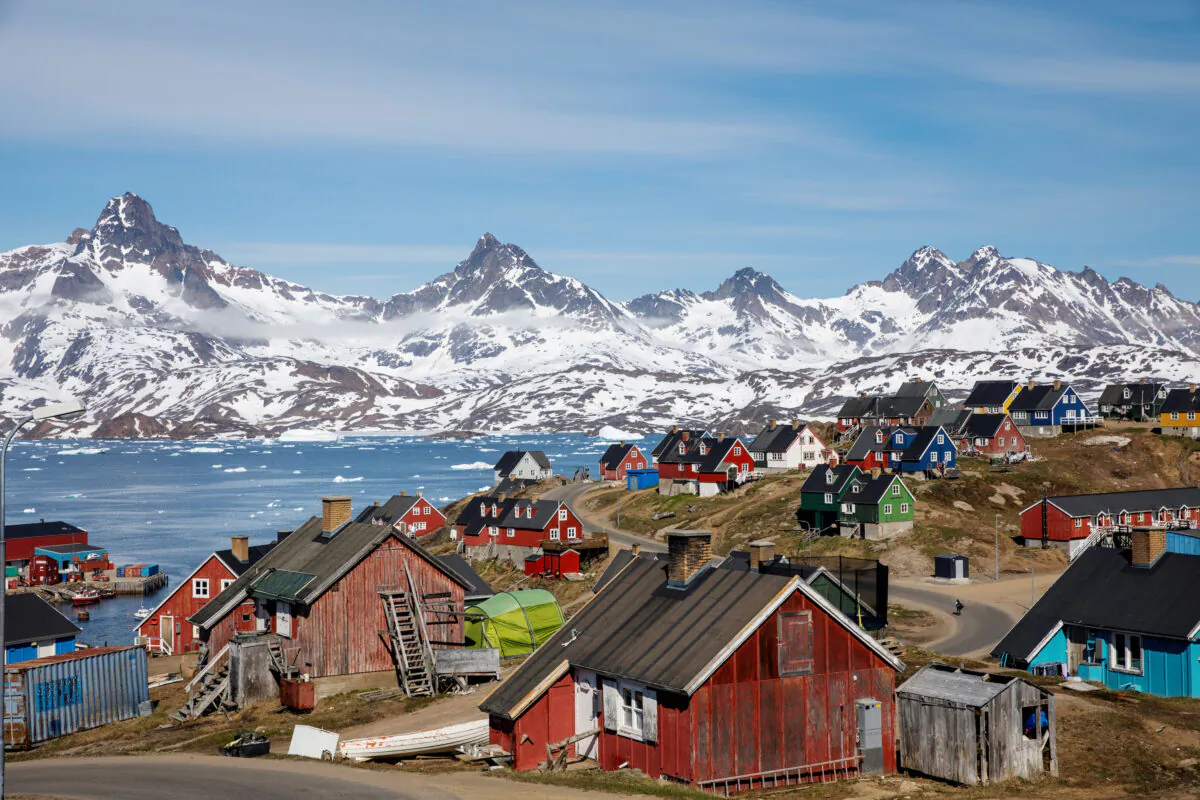 Snow covered mountains rise above the harbor and town of Tasiilaq, Greenland on June 15, 2018. (Lucas Jackson/Reuters)