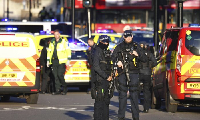 Armed police at the scene of an incident on London Bridge in central London following a police incident, on Nov. 29, 2019. (Dominic Lipinski/PA via AP)