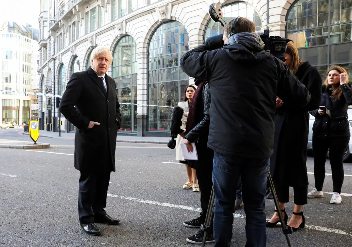 Britain's Prime Minister Boris Johnson speaks to the media at the scene of a stabbing on London Bridge, in which two people were killed, in London, Britain on Nov. 30, 2019. (Simon Dawson/Pool/Reuters)